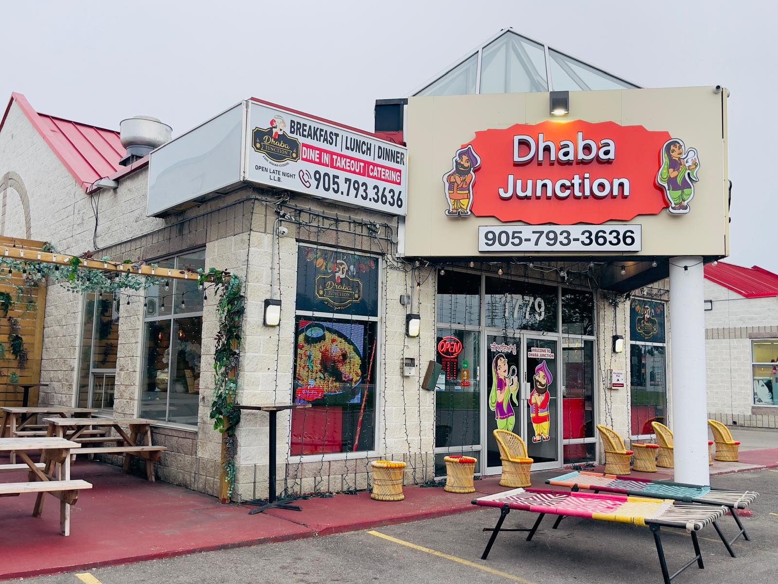 Exterior view of near me Indian restaurant Dhaba Junction featuring signage and outdoor seating area.